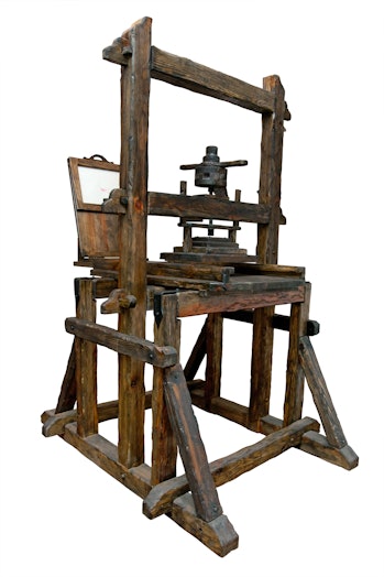 A wooden printing press designed by Gutenberg.