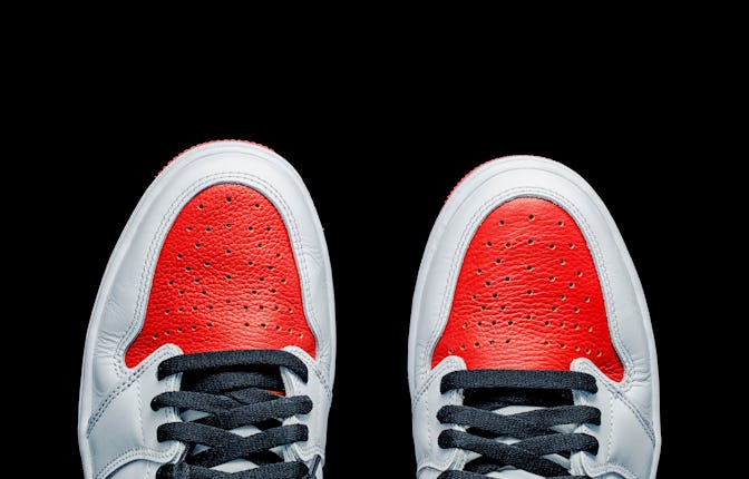Top view of sneaker with copy space. Pair of red and white sneakers on black background. Minimalist ...