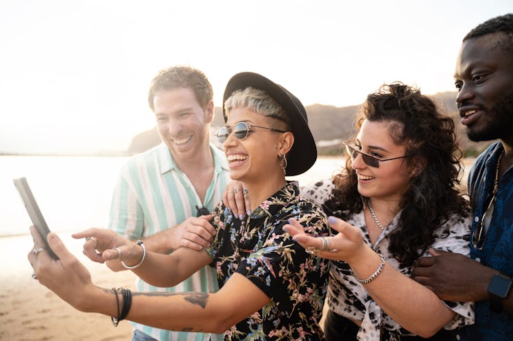 Group of laughing friends use funny Instagram Reel captions and add captions to a Reel for their fun...