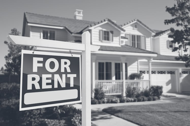 Right Facing Red For Rent Real Estate Sign in Front of Beautiful House.