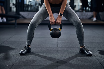 Modify a sumo squat by adding weights.