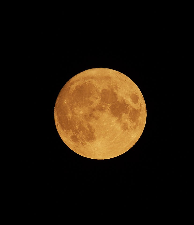 Full Orange Moon movement across the sky on July 23, 2021. Halloween Moon concept.