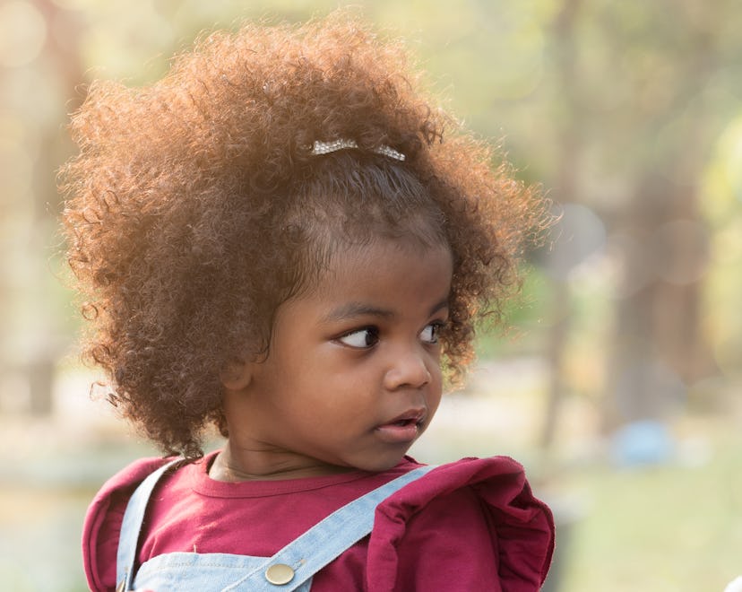 Close up portrait of a toddler girl in the park in an article about baby names that start with W