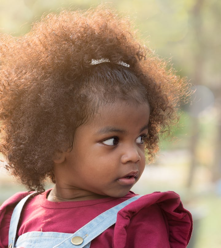 Close up portrait of a toddler girl in the park in an article about baby names that start with W