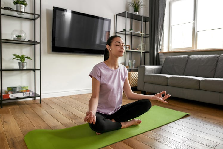 A woman practices breathing exercises, one of the free ways to practice self care.