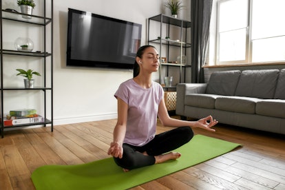 A woman practices breathing exercises, one of the free ways to practice self care.