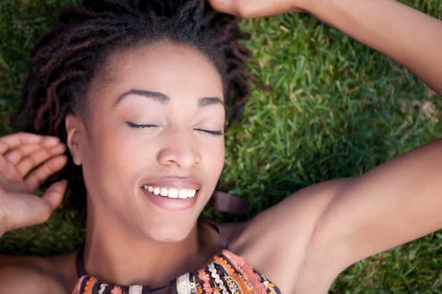 Smiling woman laying in grass