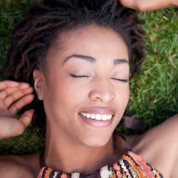 Smiling woman laying in grass