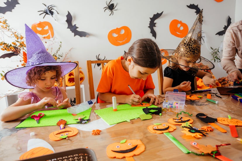 Happy children during Halloween art lesson at home