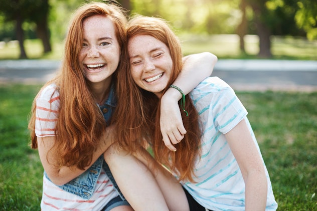 Wanna hug her forever. Portrait of happy and carefree two twin sisters with natural red hair and fre...