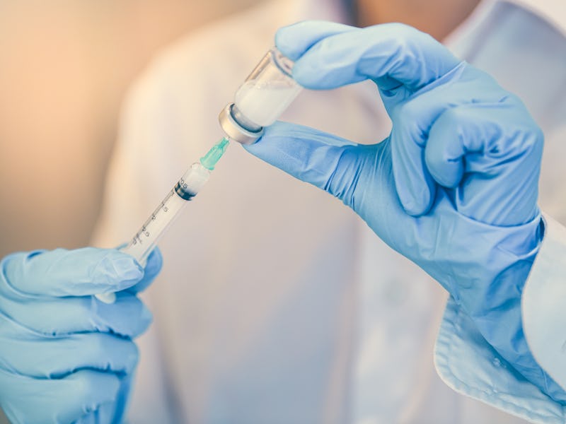 Doctor, nurse or scientist holding flu, hpv, rabies, mumps, measles, polio, or diphtheria vaccine bo...