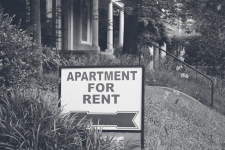 Apartment for rent sign displayed on residental street. Shows demand for housing, rental market, lan...