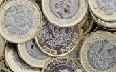 Close up of new British pound coins. Untidy pile of the new coins introduced in March 2017 that have...