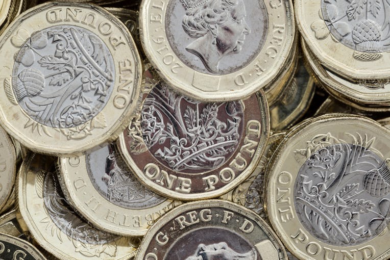 Close up of new British pound coins. Untidy pile of the new coins introduced in March 2017 that have...