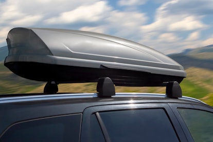 plastic luggage compartment on a car roof in summer day