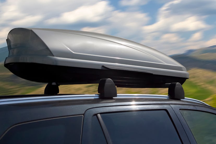 plastic luggage compartment on a car roof in summer day