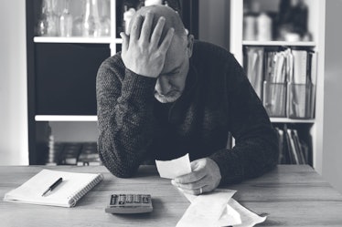 Man upset headache depressed from family cost got higher doing accounting holding receipts from supe...