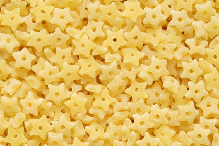 Small star shaped stelline pasta for soup texture or background.