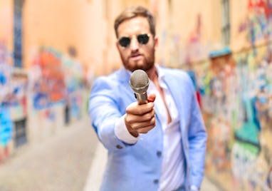 Fashionable man Making an interview on busy street