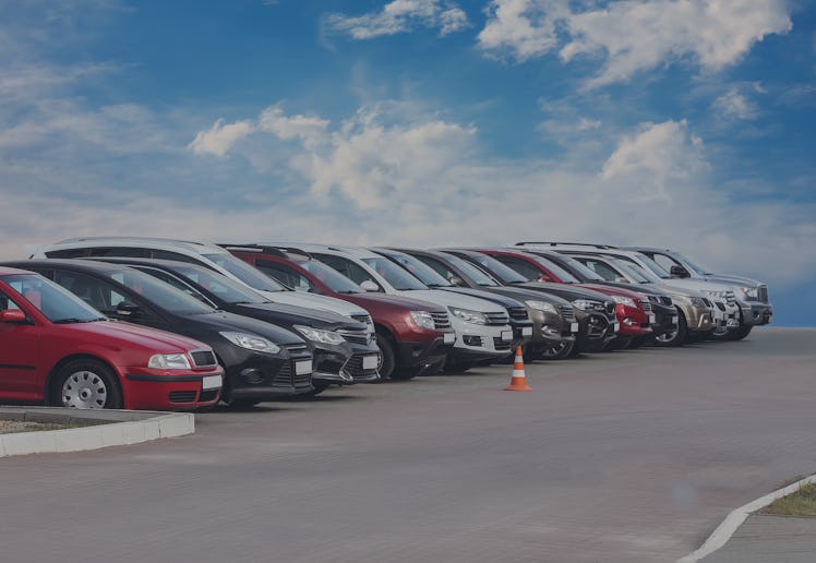 A row of cars for sale in a lot.