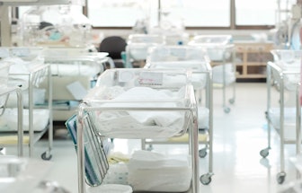 Unidentified new born babies in maternity hospital. Newborn and Childbearing center room in modern h...