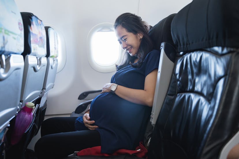 Asian pregnant women enjoy traveling go on vacation by airplane in article about flying while pregna...