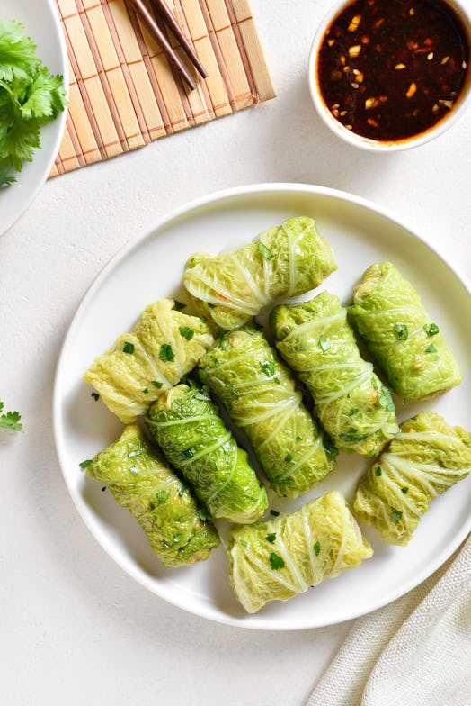 Chinese style stuffed cabbage rolls over white stone background. Top view, flat lay
