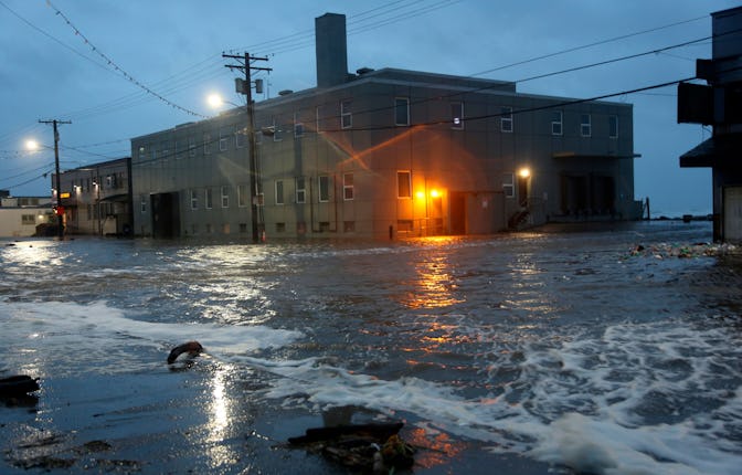 Water rushes down Front Street, just a half block from the Bering Sea, in Nome, Alaska, on . Much of...