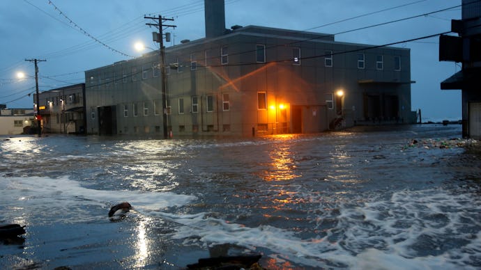 Water rushes down Front Street, just a half block from the Bering Sea, in Nome, Alaska, on . Much of...