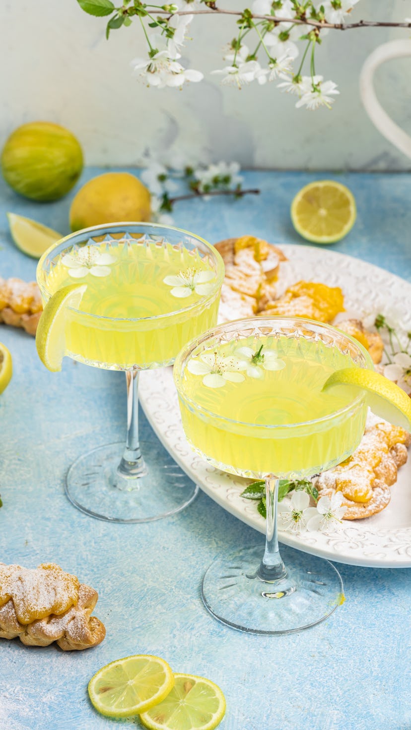 Limoncello. Traditional italian homemade alcoholic drink in glass with pieces of lemon, sweet Italia...