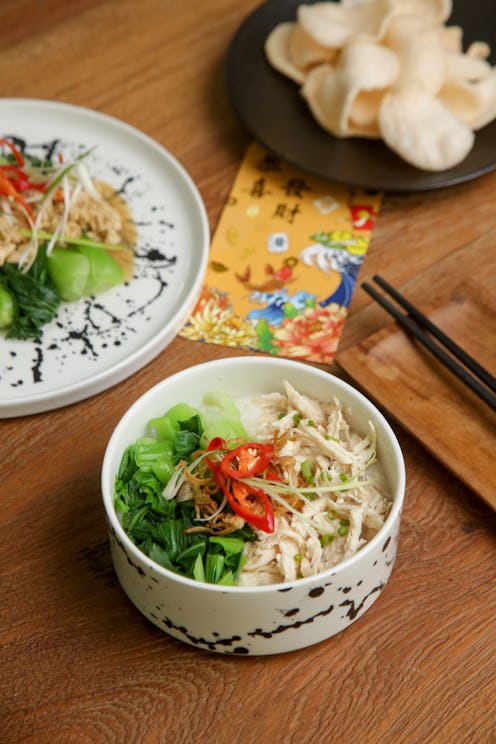 Foods to eat on Lunar New Year’s Eve on the table with golden envelope stuffed with money as a token...