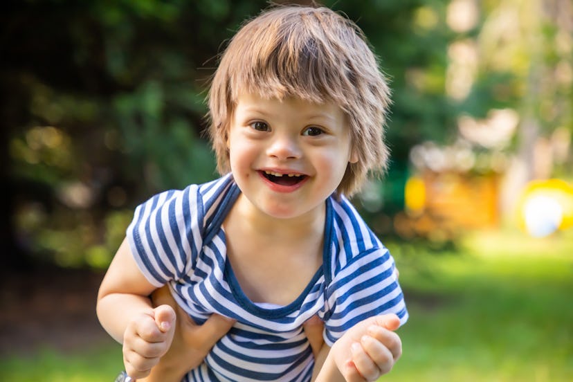 Portrait of Cute baby boy with Down syndrome playing. Some 4 letter boy names are quite trendy.