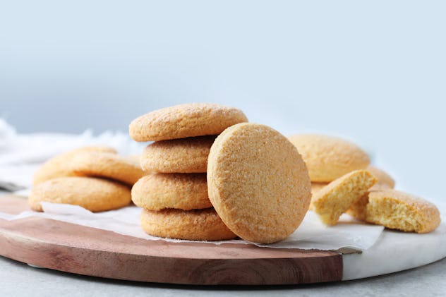Sugar cookies made without eggs on a wooden board.