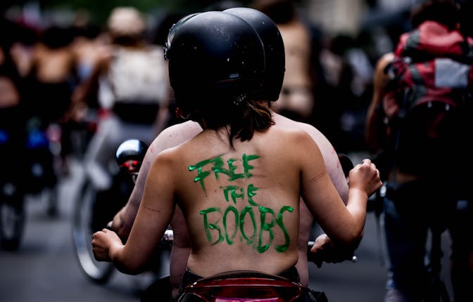 An Activist with a slogan 'Free The Boobs' takes part in a rally called 'No nipple is free until al...