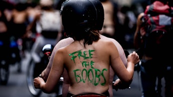 An Activist with a slogan 'Free The Boobs'  takes part in a rally called 'No nipple is free until al...