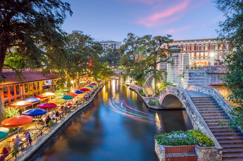 River walk in San Antonio city downtown skyline cityscape of Texas USA at sunset