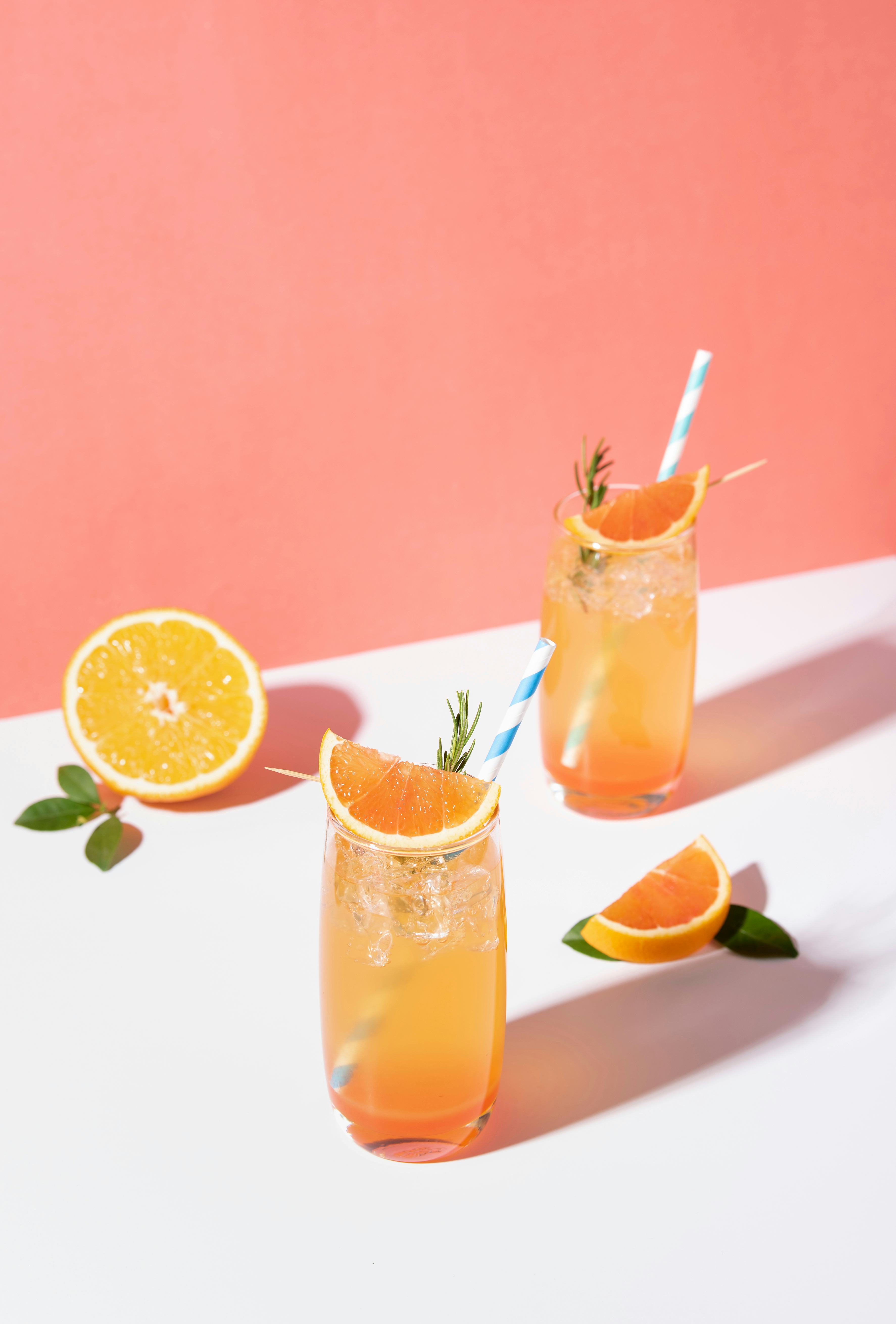 Cold and refreshing orange punch cocktail with orange slice on color background. summer drink.