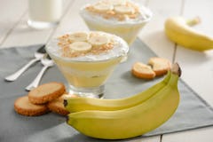 Ripe bananas, cookies for cream pudding. Beautiful and tasty dessert, two portions. Food to cheer yo...