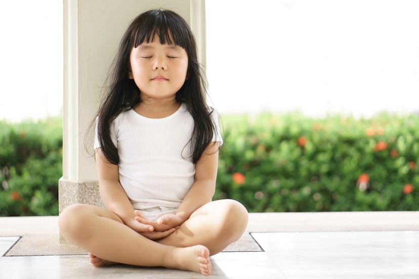 A girl wearing white meditates. Xen is a girl's name that begins with X.