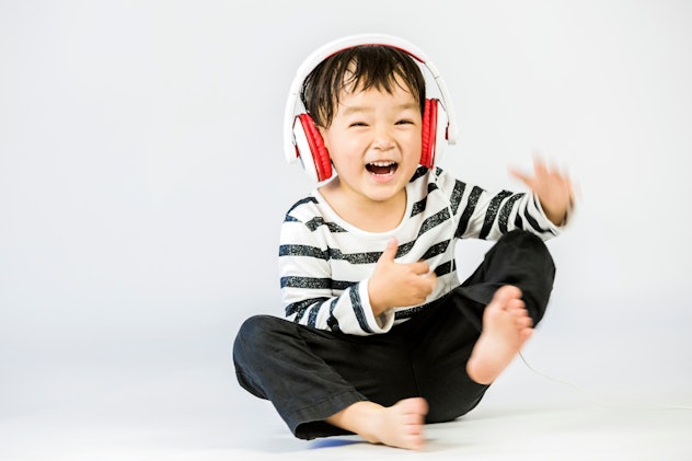 Boy listen to music on a white background. Xen is a cool X name for boys.