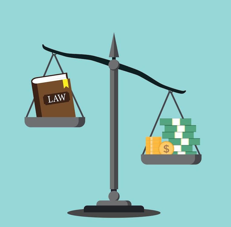 Balance balancing money and the book of law, concept of injustice and corruption, money and law bala...