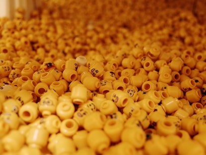 A bin of LEGO mini-fig heads.