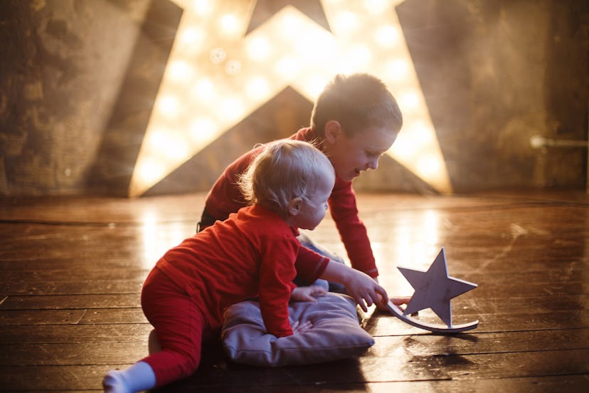 Children play with a wooden toy on the background of lights. We gathered unique celestial names for ...