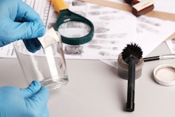 Forensic fingerprint analysis, criminalist collects latent fingerprints using fingerprint powder on ...