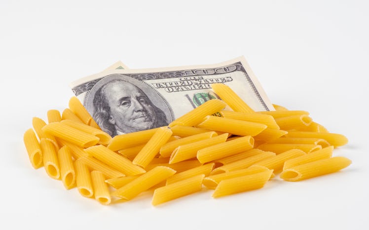 American money and Pasta on a white background. The concept of rising food prices and deficien . Res...