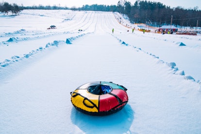 Empty snow tube at the top of a slope, in a story answering the question, can you go tubing while pr...