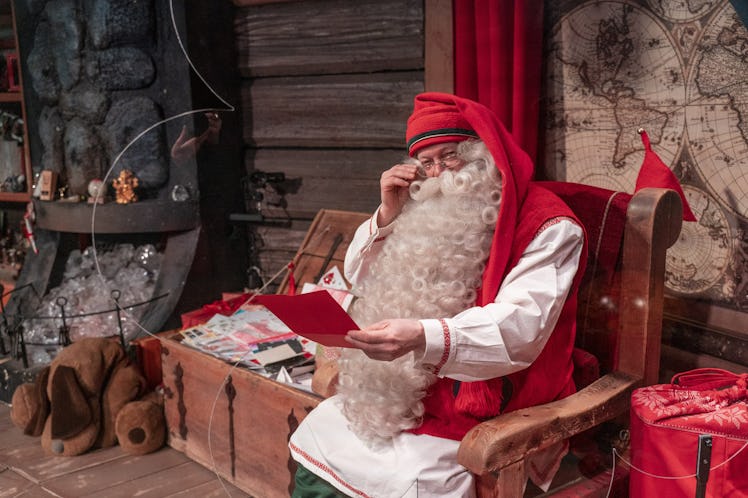 Santa Claus, also known as Father Christmas, reading his mail at the Santa's Office at the Santa's V...