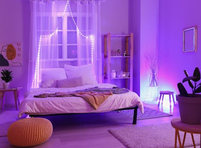 Interior of stylish bedroom with neon lighting