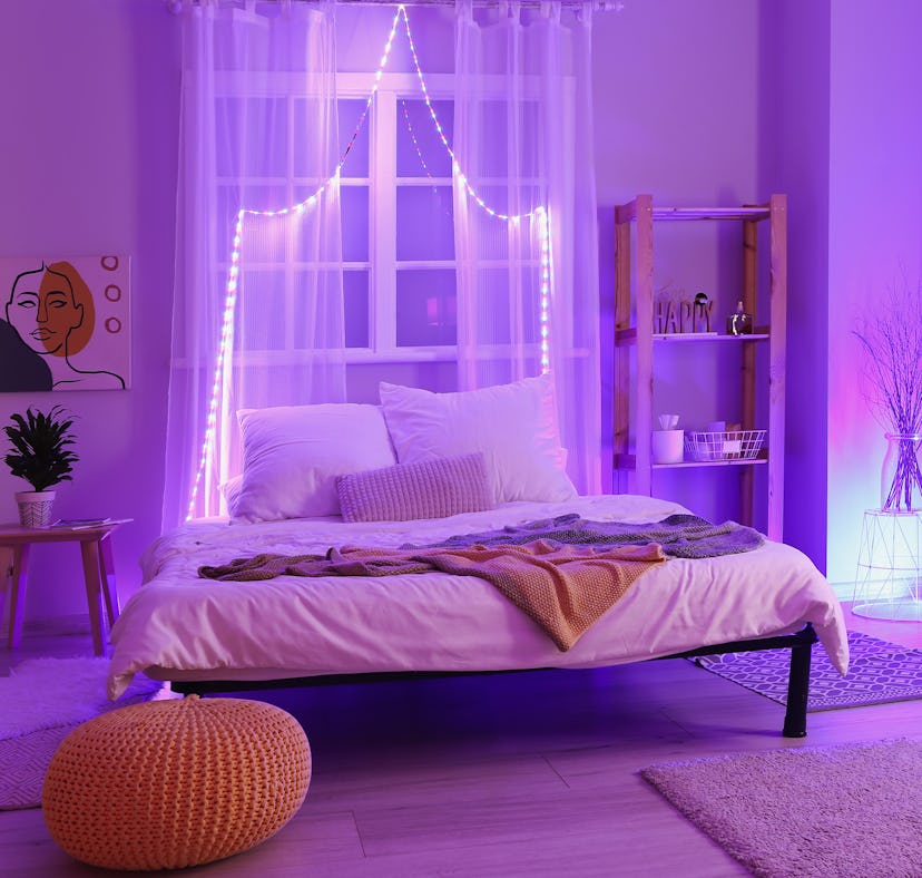 Interior of stylish bedroom with neon lighting