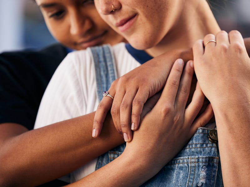 Hands, love and lgbt with a woman couple hugging outdoor for romance, dating or non binary affection...